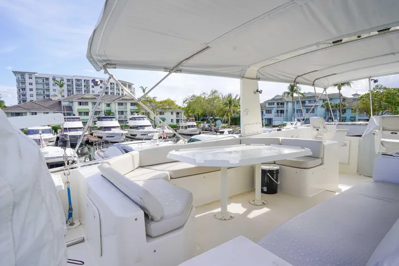 Slide: The Image of 1991 Viking 65 Cockpit yacht interior with seating area, marina view, and modern amenities. - 46
