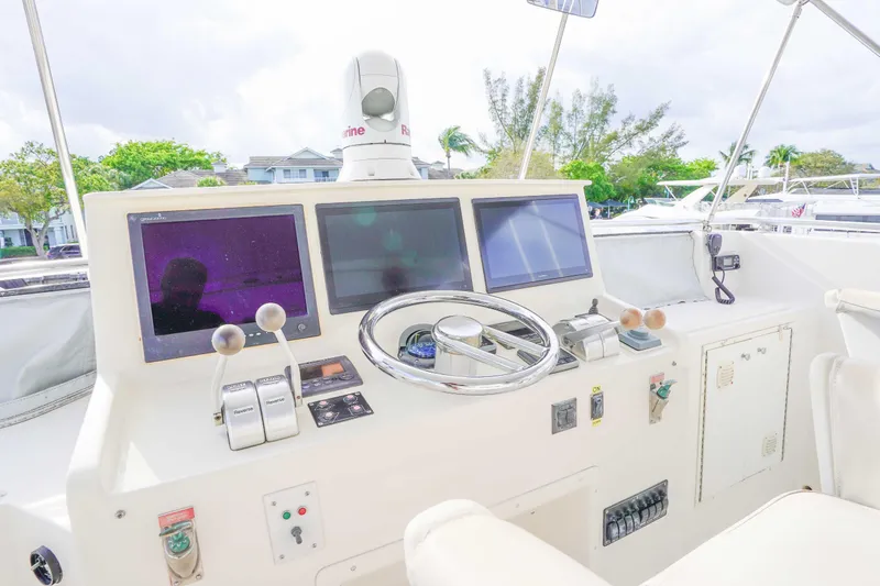 Slide: The Image of Cockpit of a 1991 Viking 65 yacht with modern navigation equipment and controls. - 49