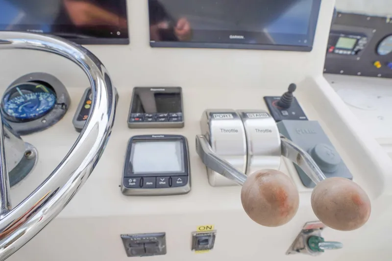 Slide: The Image of Control panel of a 1991 Viking 65 Cockpit yacht with steering wheel and throttle levers. - 50