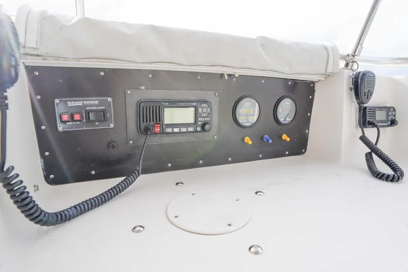 Slide: The Image of Control panel of a 1991 Viking 65 Cockpit boat with communication equipment. - 51