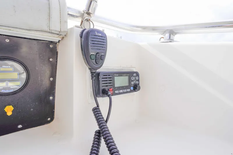 Slide: The Image of VHF radio and gauge on 1991 Viking 65 Cockpit boat dashboard. - 52