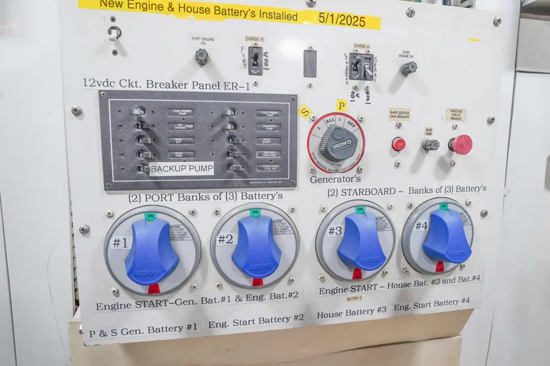 Slide: The Image of Control panel of a 1991 Viking 65 Cockpit boat with battery switches and circuit breakers. - 56