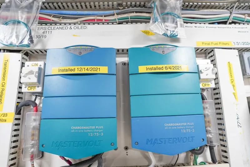 Slide: The Image of Electrical panel with two Mastervolt battery chargers on a 1991 Viking 65 Cockpit yacht. - 57