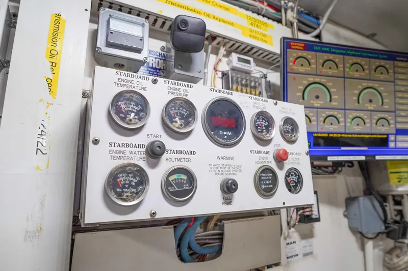 Slide: The Image of Control panel of a 1991 Viking 65 Cockpit boat with gauges and digital display. - 58