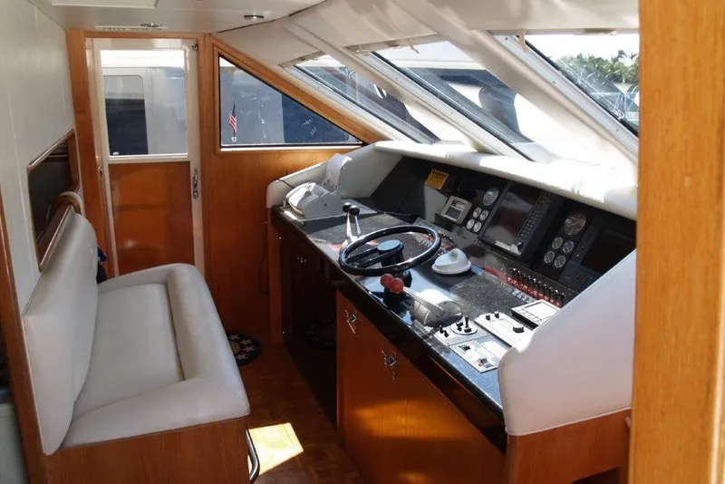 Slide: The Image of Interior of 1991 Viking 65 Cockpit yacht with steering controls and seating area. - 9