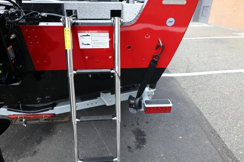 Slide: The Image of 2026 Lund 1775 Impact XS Sport boat rear view with ladder and safety features. - 10