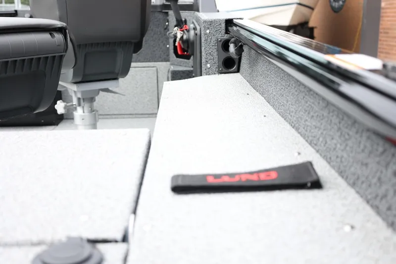 Slide: The Image of 2026 Lund 1775 Impact XS Sport boat interior with seating and storage features. - 11
