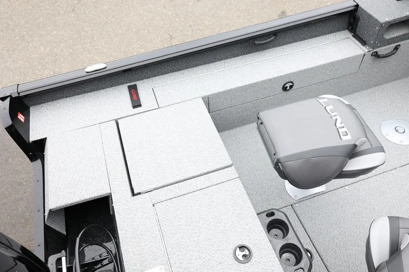 Slide: The Image of 2026 Lund 1775 Impact XS Sport boat interior with gray seating and storage compartments. - 13