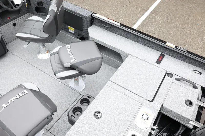 Slide: The Image of 2026 Lund 1775 Impact XS Sport boat interior with gray seating and storage compartments. - 14
