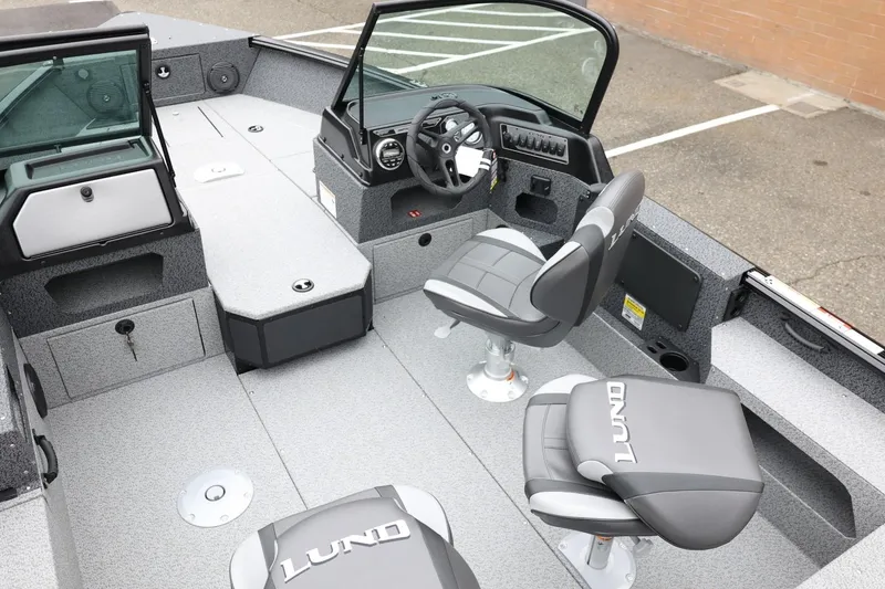 Slide: The Image of 2026 Lund 1775 Impact XS Sport boat interior with seating and steering console. - 15