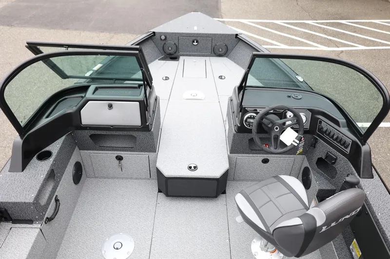 Slide: The Image of 2026 Lund 1775 Impact XS Sport boat interior with steering console and seating. - 17