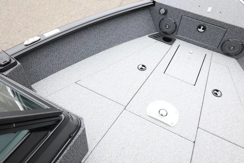 Slide: The Image of 2026 Lund 1775 Impact XS Sport boat interior with storage compartments and speakers. - 18