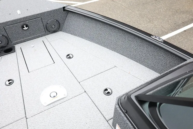 Slide: The Image of 2026 Lund 1775 Impact XS Sport boat interior with storage compartments and speakers. - 19