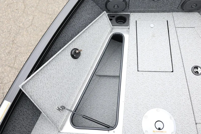 Slide: The Image of 2026 Lund 1775 Impact XS Sport boat interior storage compartment open. - 20