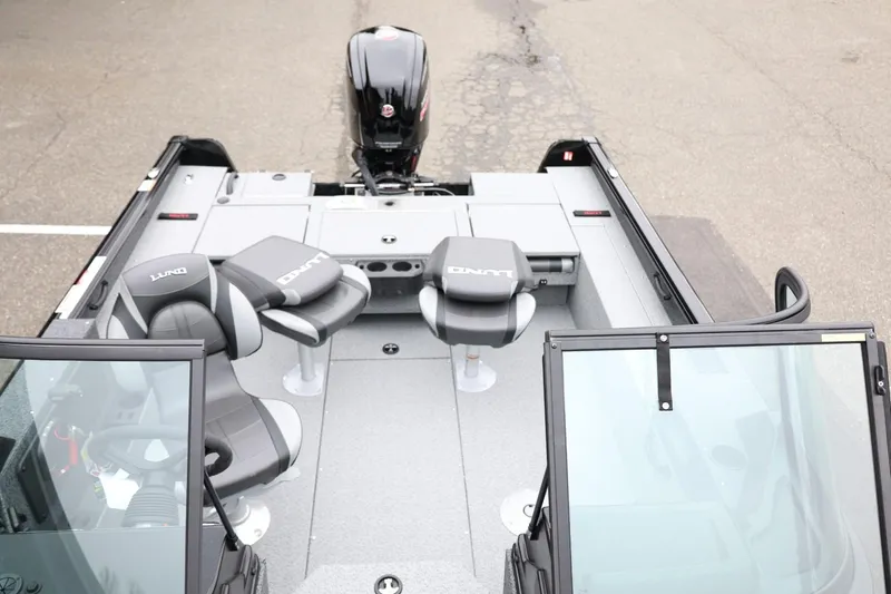 Slide: The Image of 2026 Lund 1775 Impact XS Sport boat interior with seating and motor, top view. - 24