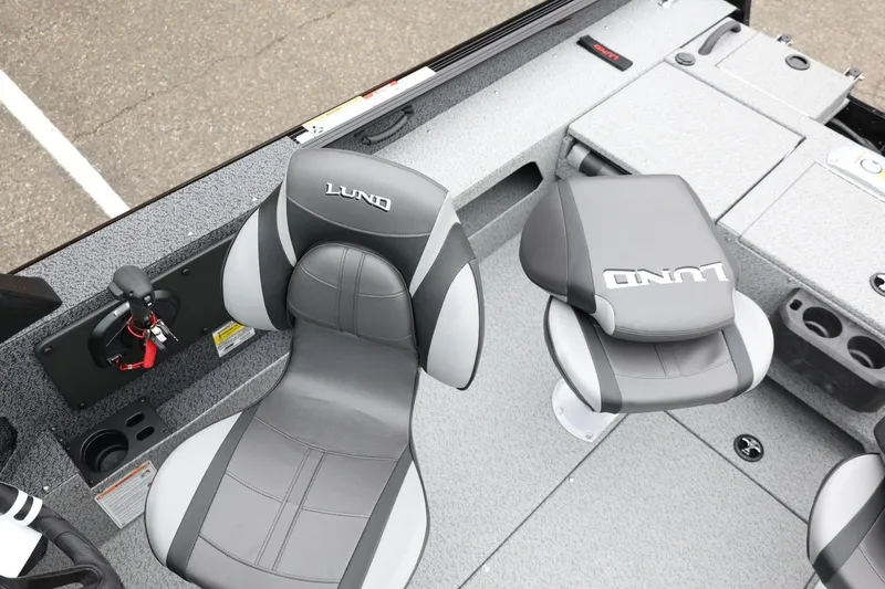 Slide: The Image of 2026 Lund 1775 Impact XS Sport boat interior with gray seating and console. - 25