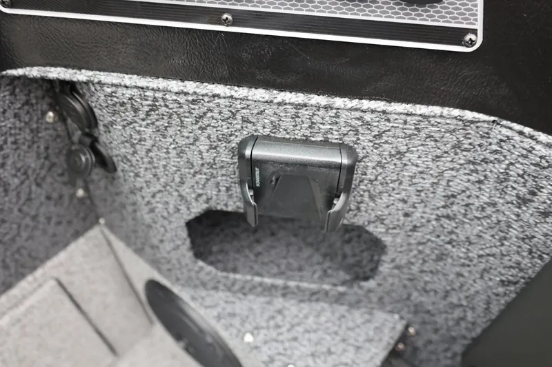 Slide: The Image of Interior detail of 2026 Lund 1775 Impact XS Sport boat, featuring textured paneling and storage compartment. - 30