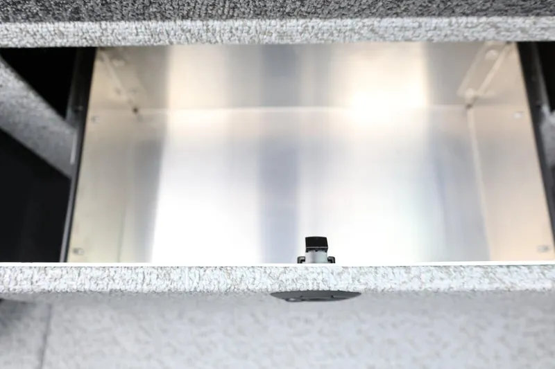 Slide: The Image of 2026 Lund 1775 Impact XS Sport boat storage compartment, featuring a sleek metallic interior. - 33