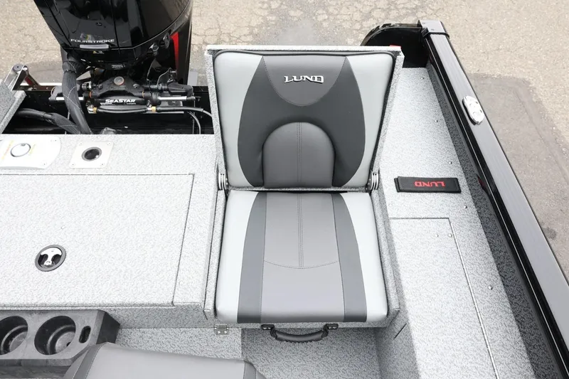 Slide: The Image of 2026 Lund 1775 Impact XS Sport boat seat with gray upholstery and motor detail. - 38