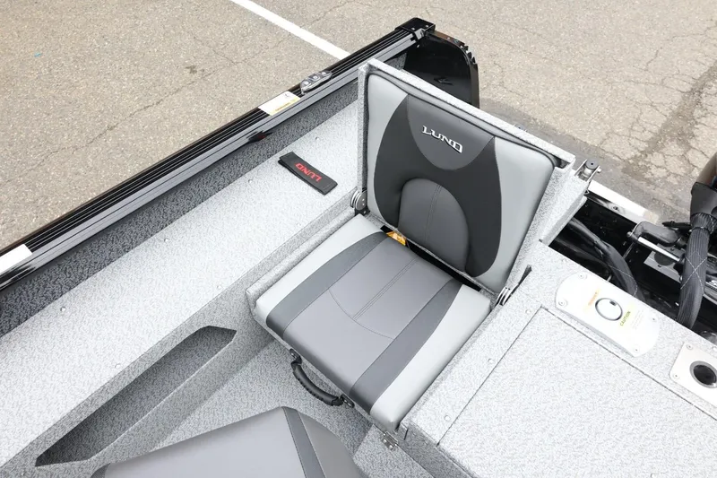 Slide: The Image of 2026 Lund 1775 Impact XS Sport boat seat, gray and black design, on textured flooring. - 39