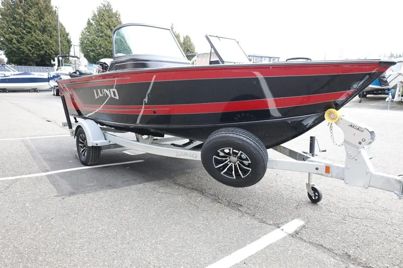 Slide: The Image of 2026 Lund 1775 Impact XS Sport boat on trailer, black with red accents. - 4