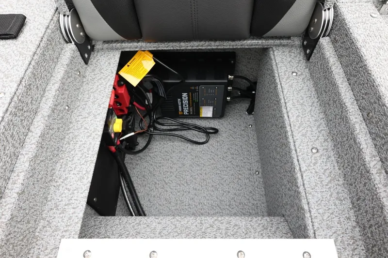 Slide: The Image of 2026 Lund 1775 Impact XS Sport boat battery compartment with charger and wiring. - 42