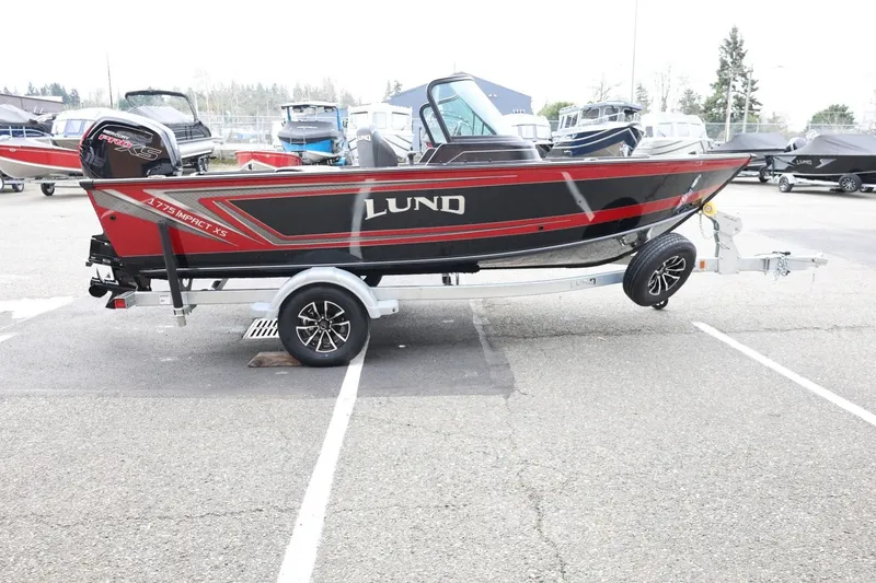 Slide: The Image of 2026 Lund 1775 Impact XS Sport boat on trailer in parking lot. - 5