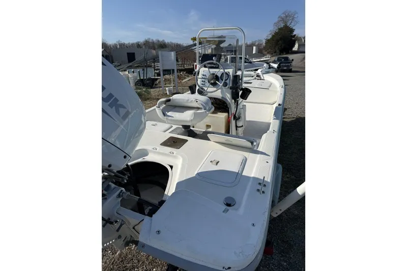 Slide: The Image of 2006 Carolina Skiff JV17 boat with Suzuki outboard motor, parked outdoors. - 3