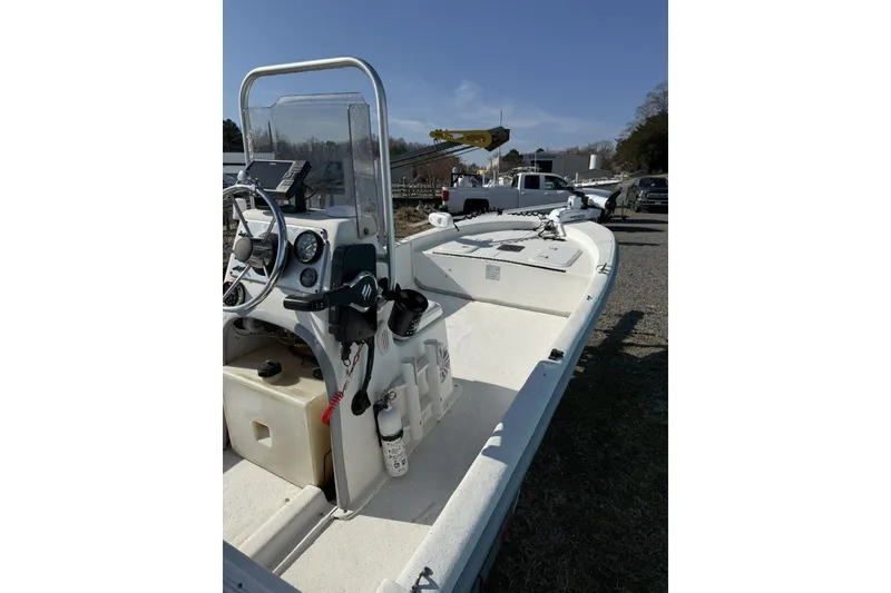 Slide: The Image of 2006 Carolina Skiff JV17 boat with console and steering wheel, parked outdoors. - 4