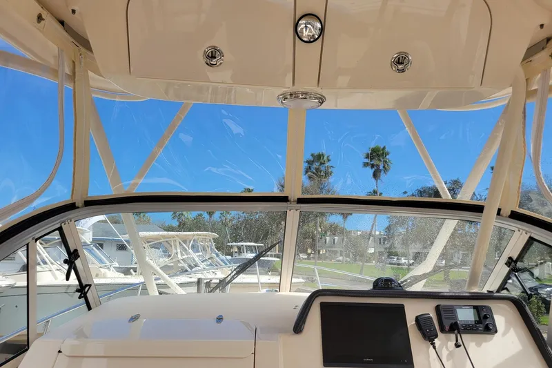 Slide: The Image of Interior view of 2023 Grady-White Gulfstream 232 boat with clear windshield and dashboard. - 13