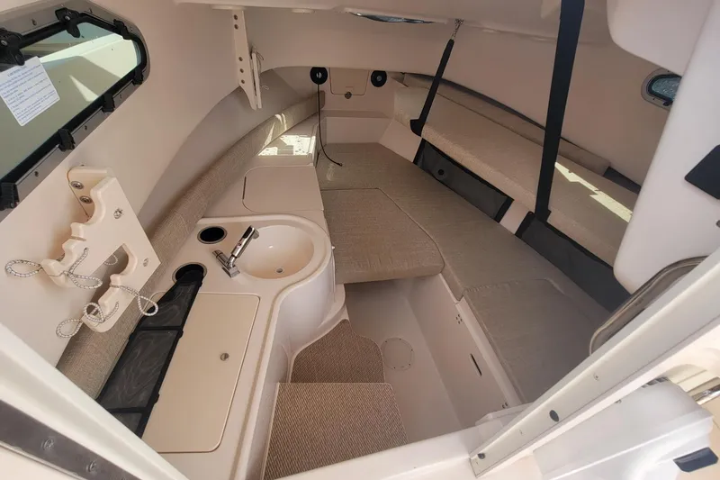 Slide: The Image of 2023 Grady-White Gulfstream 232 cabin interior with seating and sink. - 14