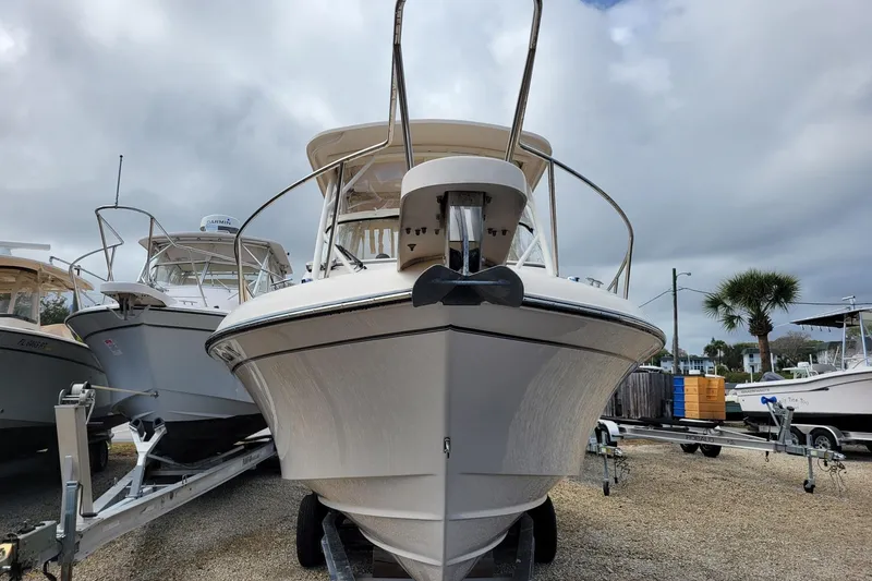 Slide: The Image of 2023 Grady-White Gulfstream 232 boat on trailer, cloudy sky background. - 2