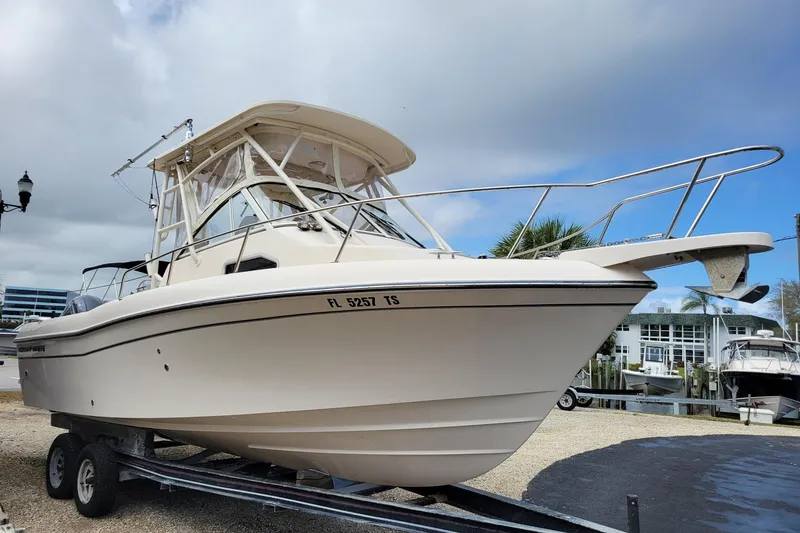 Slide: The Image of 2023 Grady-White Gulfstream 232 boat on trailer, parked outdoors under cloudy sky. - 3