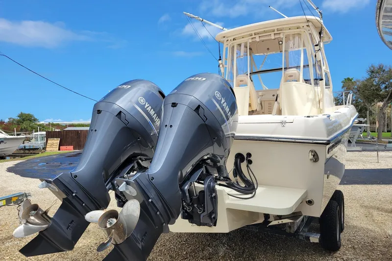 Slide: The Image of 2023 Grady-White Gulfstream 232 boat with dual Yamaha outboard engines, parked outdoors. - 4