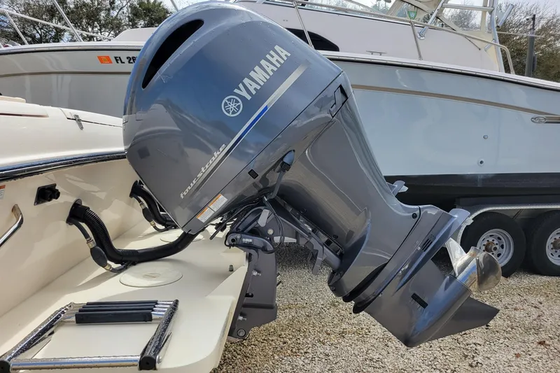 Slide: The Image of 2023 Grady-White Gulfstream 232 with Yamaha outboard motor, parked on gravel. - 7