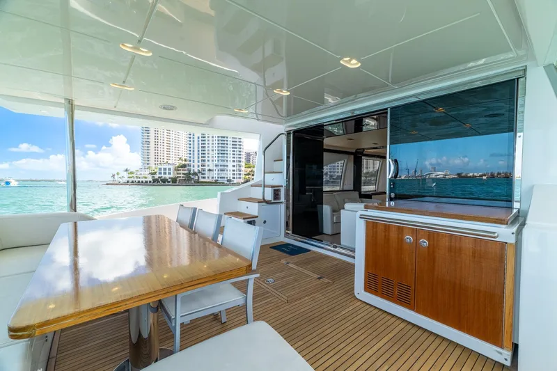 Slide: The Image of Luxurious 2015 Azimut 80 yacht interior with dining area, overlooking scenic waterfront views. - 10