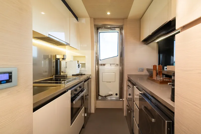 Slide: The Image of Luxurious kitchen interior of a 2015 Azimut 80 yacht, featuring modern appliances and sleek design. - 16