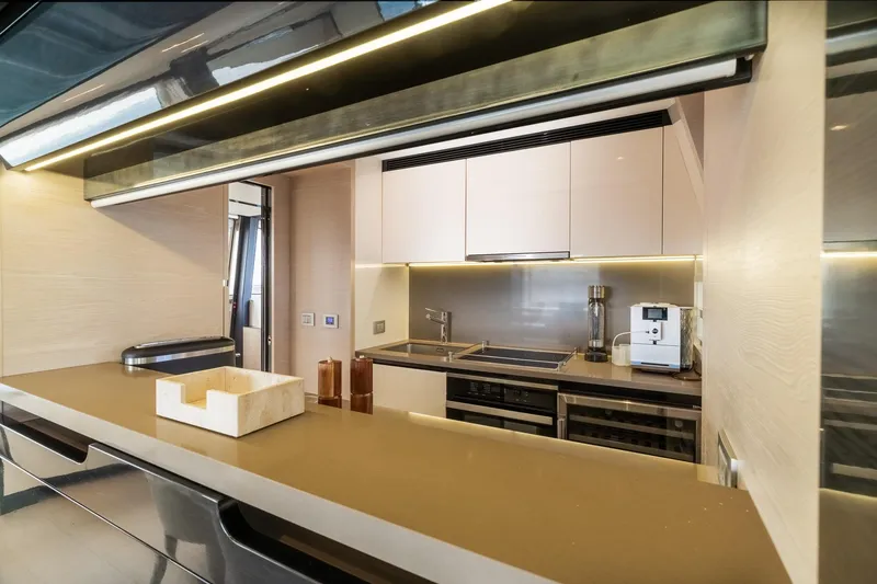 Slide: The Image of Modern kitchen interior on 2015 Azimut 80 yacht, featuring sleek cabinetry and appliances. - 19