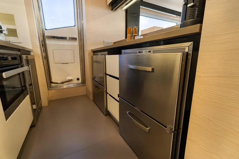 Slide: The Image of Modern kitchen interior on a 2015 Azimut 80 yacht, featuring stainless steel appliances. - 22