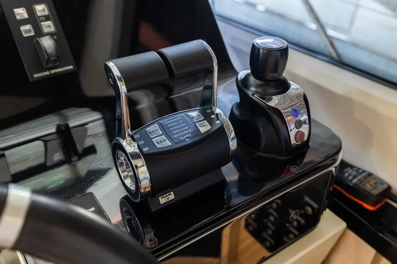 Slide: The Image of Control panel of a 2015 Azimut 80 yacht, featuring throttle and joystick controls. - 25