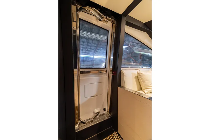 Slide: The Image of Interior view of a 2015 Azimut 80 yacht, featuring a sleek door and window. - 27
