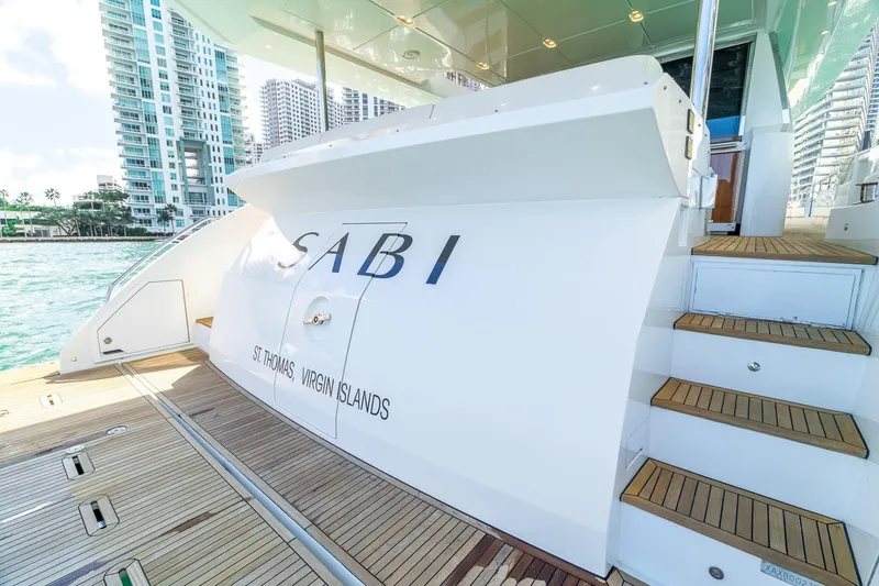 Slide: The Image of Luxury Azimut 80 yacht docked, featuring elegant wooden deck and modern design, 2015 model. - 4