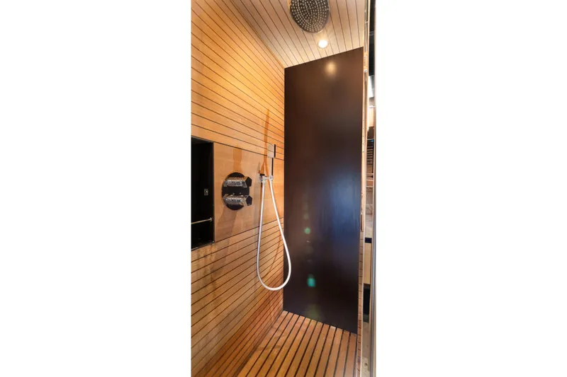 Slide: The Image of Luxurious shower interior on 2015 Azimut 80 yacht, featuring sleek wood paneling and modern fixtures. - 53