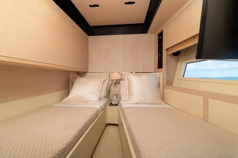 Slide: The Image of Luxurious twin cabin interior on a 2015 Azimut 80 yacht, featuring elegant bedding and modern design. - 55