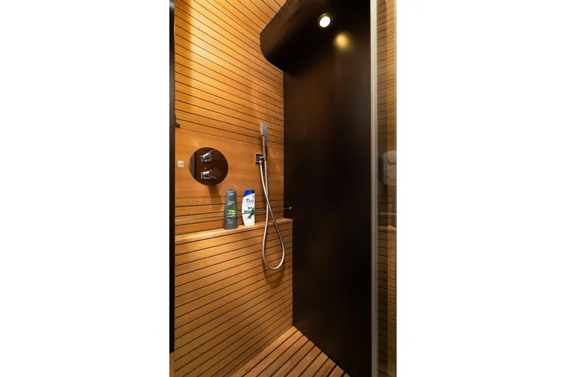Slide: The Image of Luxurious wooden shower interior on 2015 Azimut 80 yacht, featuring modern fixtures and lighting. - 58