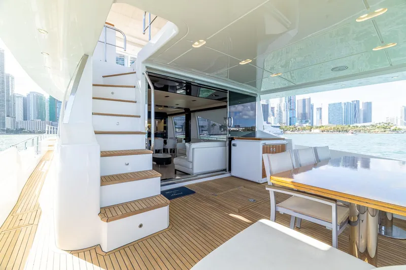 Slide: The Image of Luxurious 2015 Azimut 80 yacht interior with city skyline view, featuring elegant seating and dining area. - 6