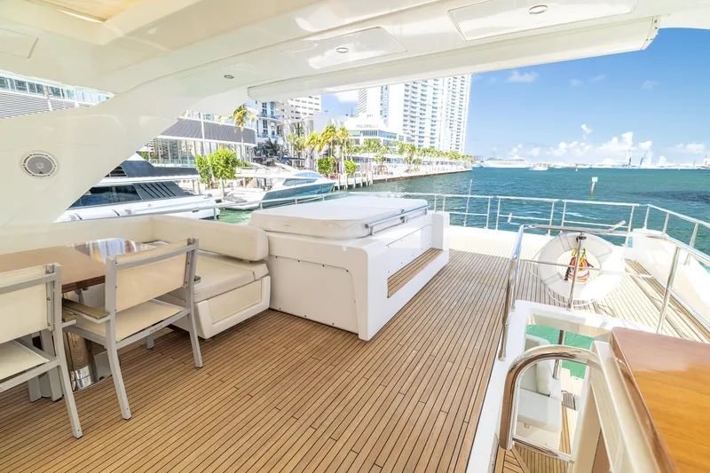 Slide: The Image of Luxurious 2015 Azimut 80 yacht deck with seating, overlooking marina and cityscape. - 68