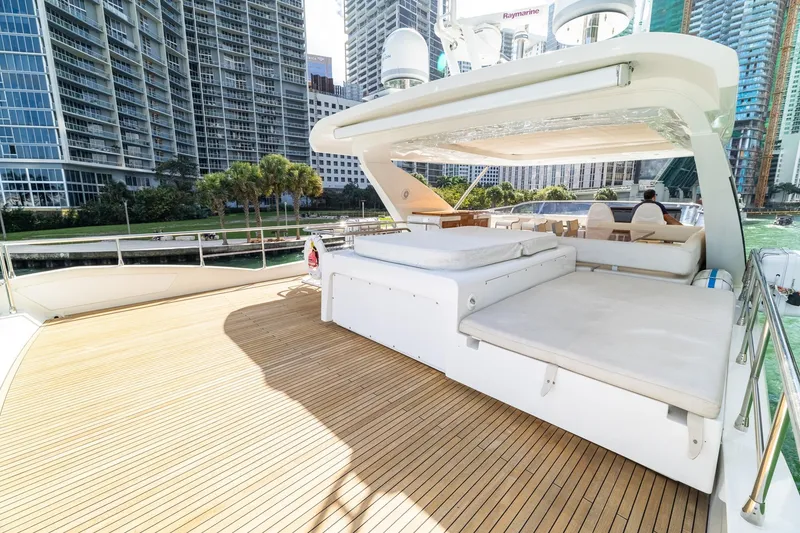 Slide: The Image of Luxurious 2015 Azimut 80 yacht deck with sunbeds, set against a cityscape backdrop. - 70
