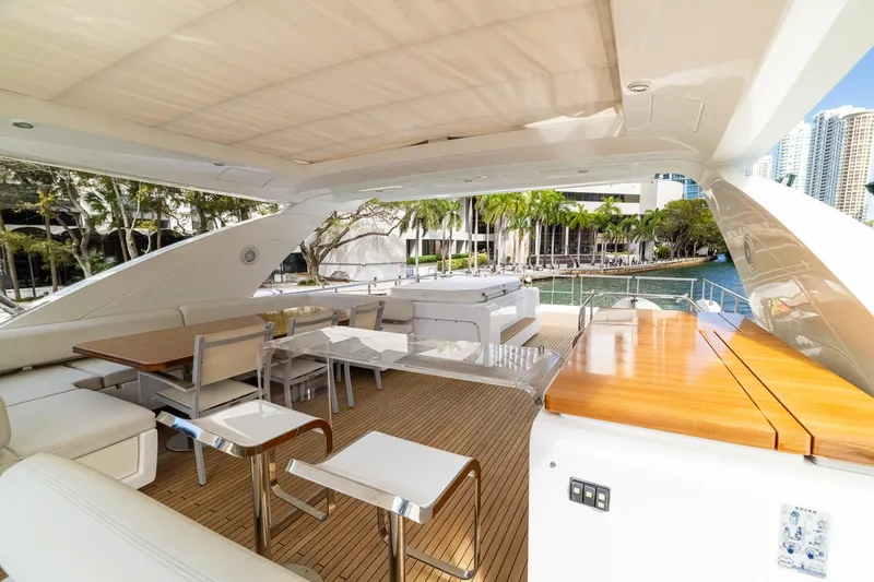 Slide: The Image of Luxurious 2015 Azimut 80 yacht deck with elegant seating and dining area, docked by waterfront. - 72