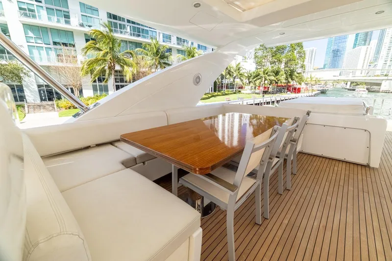 Slide: The Image of Luxurious 2015 Azimut 80 yacht deck with elegant dining area and waterfront view. - 76